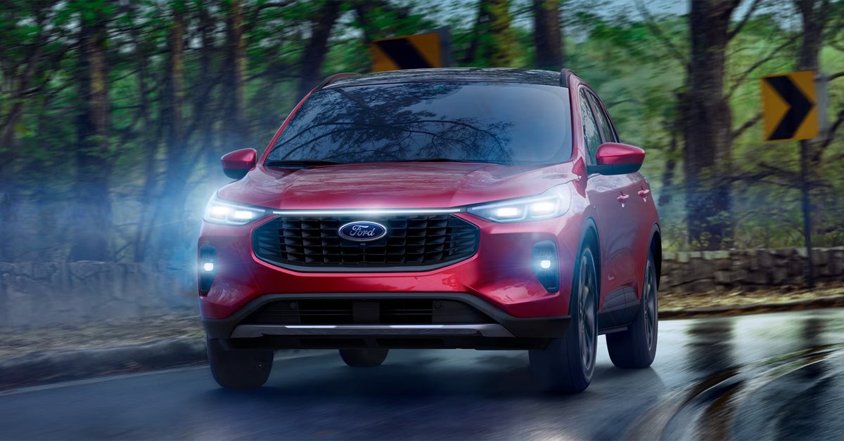 2026 Ford Escape - Driving on a winding road through a forest